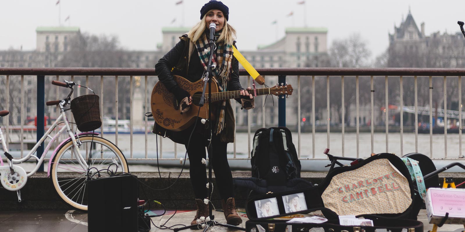 Busker girl playing an acoustic guitar