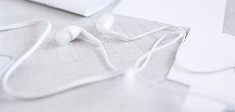 White earbuds on a desk