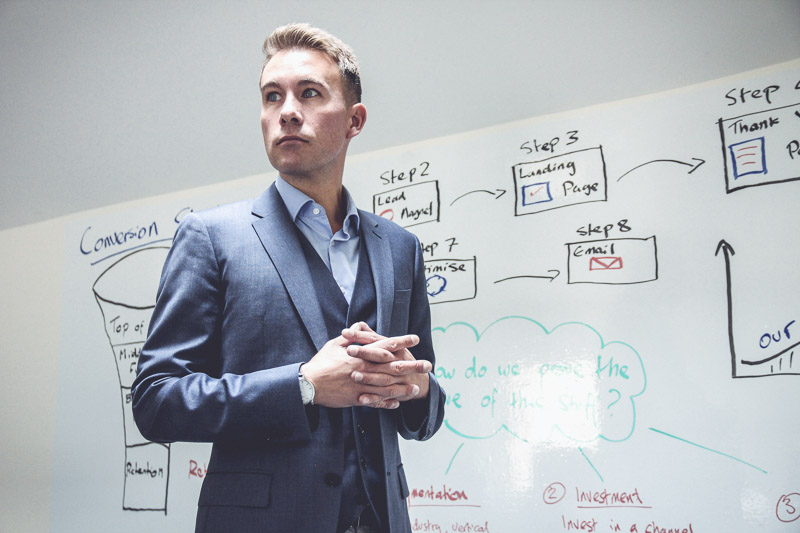 Owen Dale - standing in front of a white board, Made Easy Group, North Wales